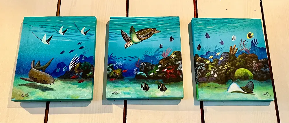3-piece painting showing an underwater scene with corals, sharks, turtles and stingrays.
