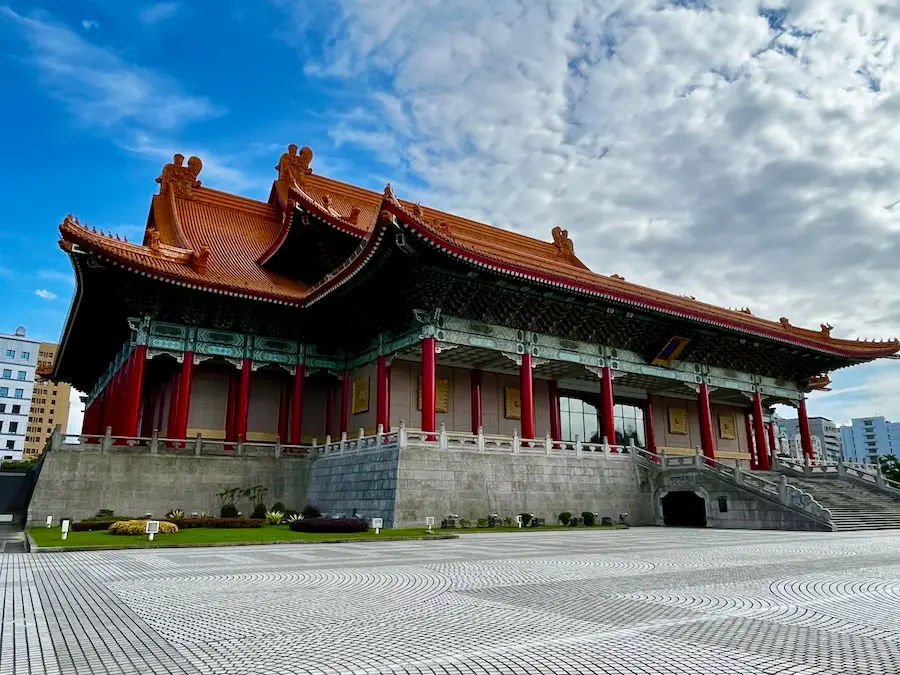 A decorative, Asian-style building with red columns.