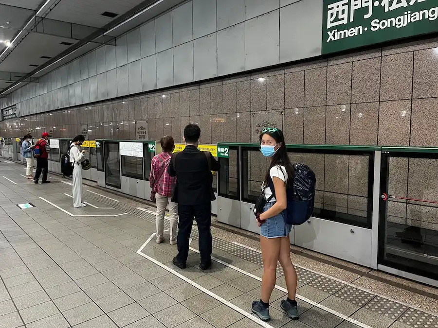 The blog author standing in line and waiting for the metro at an indoor station.