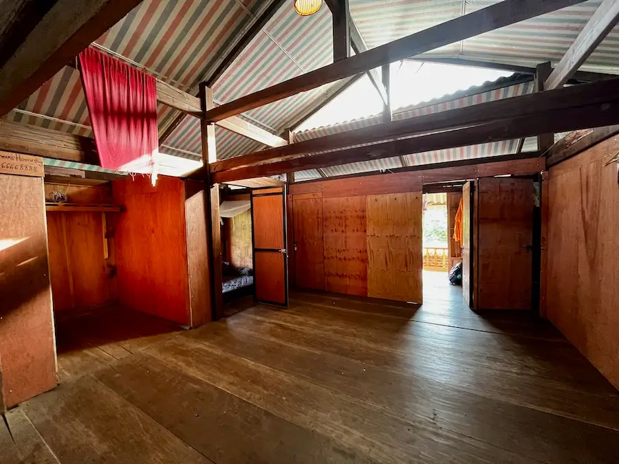 A non-decorated, wooden open floor with several rooms.