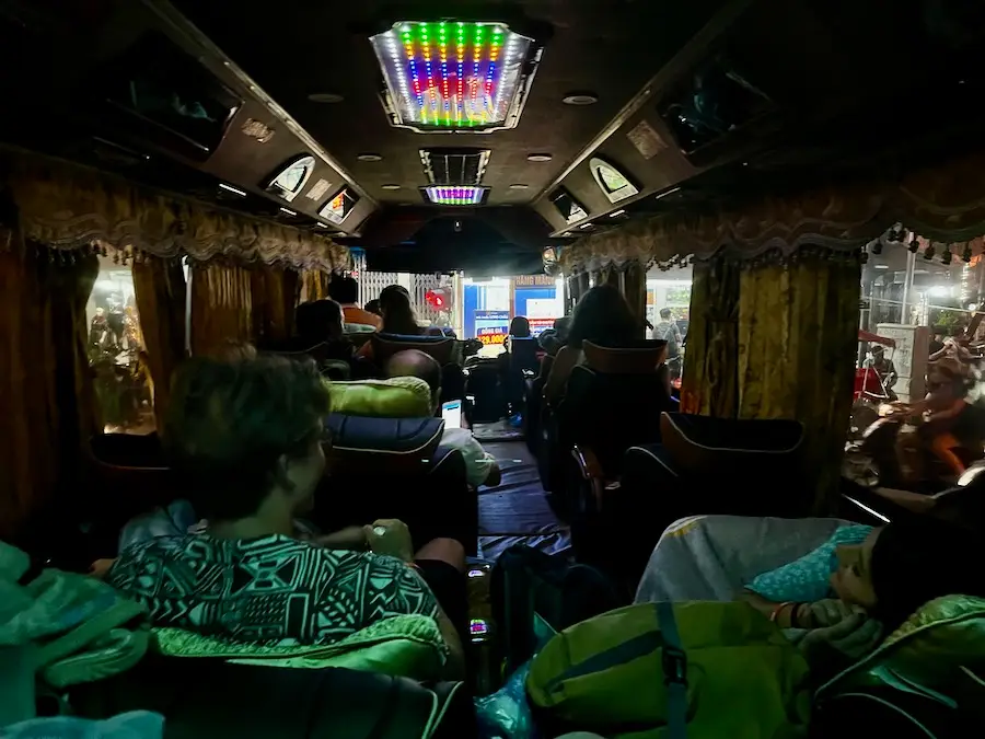 Inside a spacious bus with heavily-reclined chairs.