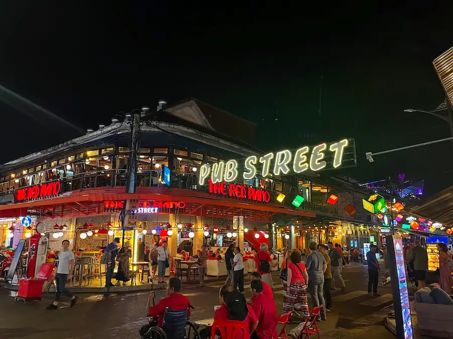 A pedestrian-only intersection with a glowing sign that says "Pub Street".