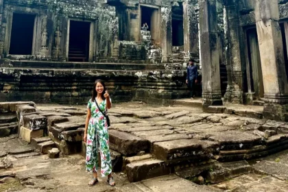The blog author wearing clothes covering her knees and shoulders while in a Cambodian temple.