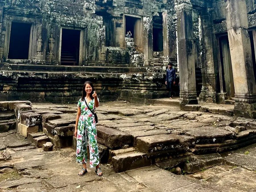 The blog author wearing clothes covering her knees and shoulders while in a Cambodian temple.