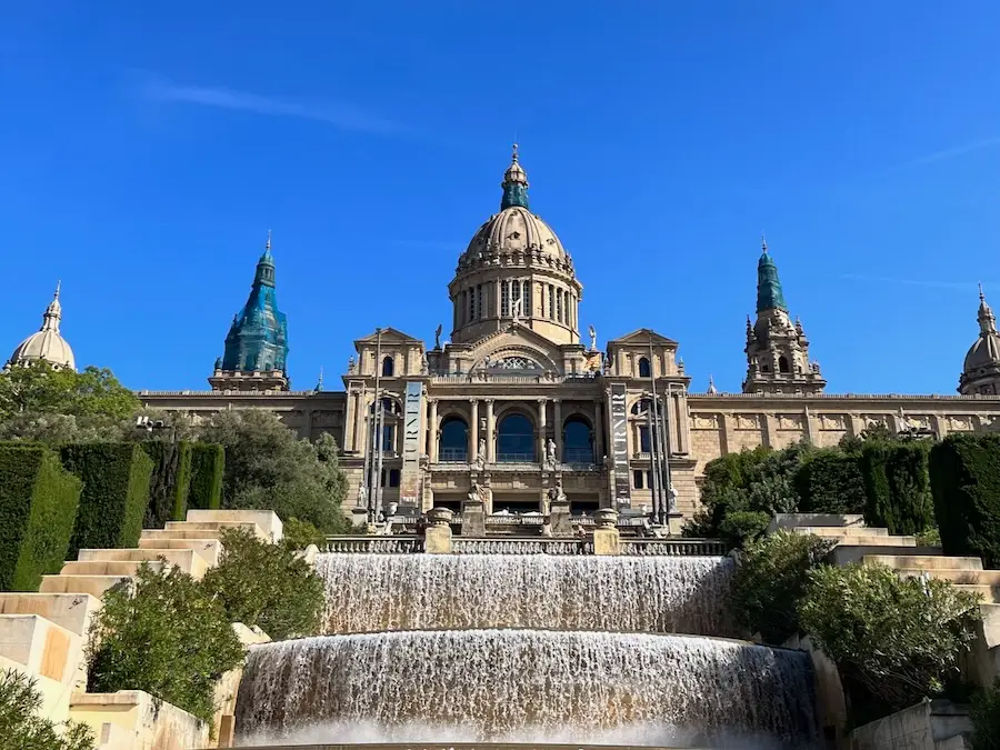 An intricate building at the top with a large fountain at the bottom.