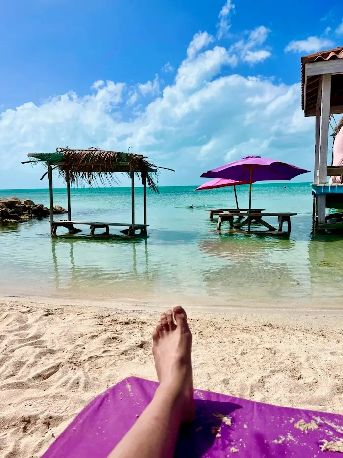 A view of the ocean on a calm, sandy beach.