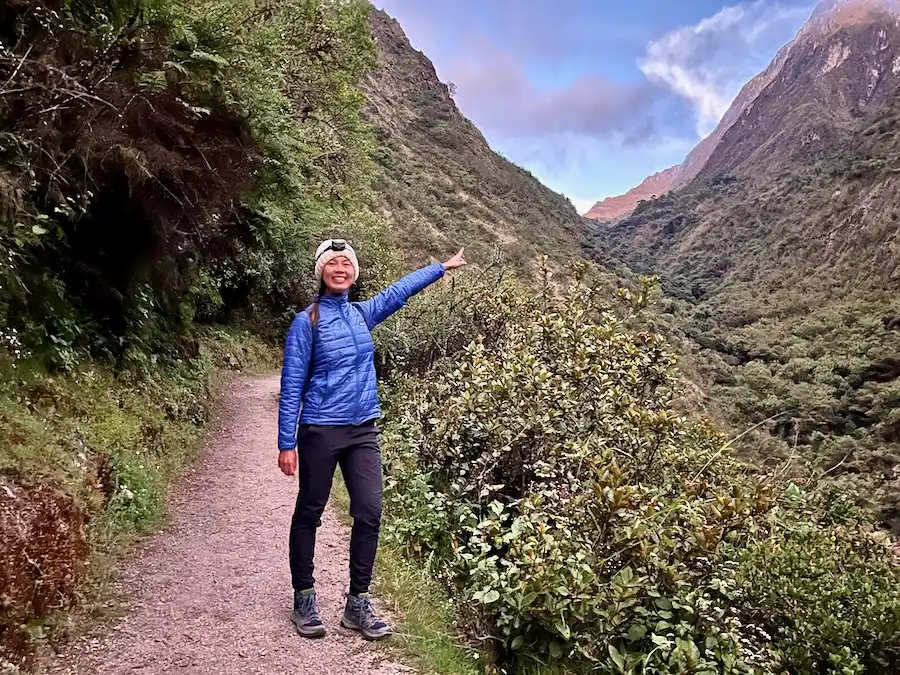 A woman on a path wearing cold gear and a headlamp.