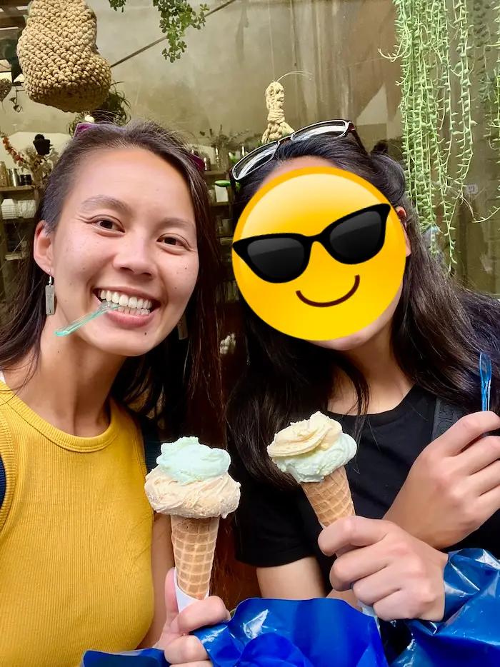 Two people holding gelatos while taking a selfie.
