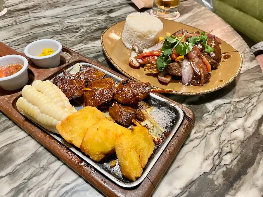 Two plates, one with beef heart and another with beef and rice.