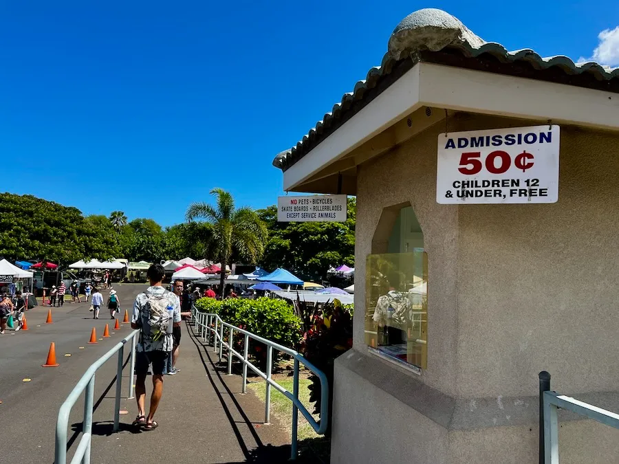 An open-air market with a sign that says "50 cents".