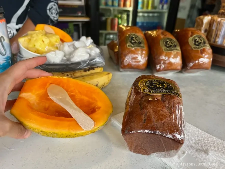 A banana bread and papaya snack wrapped in sticky wrap.