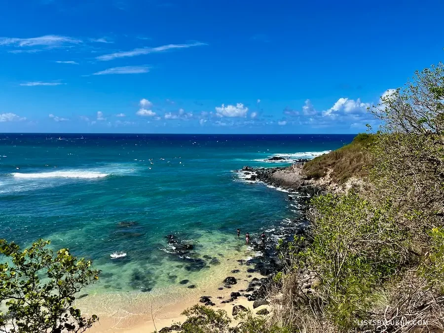 A view of a beach with turquoise water.