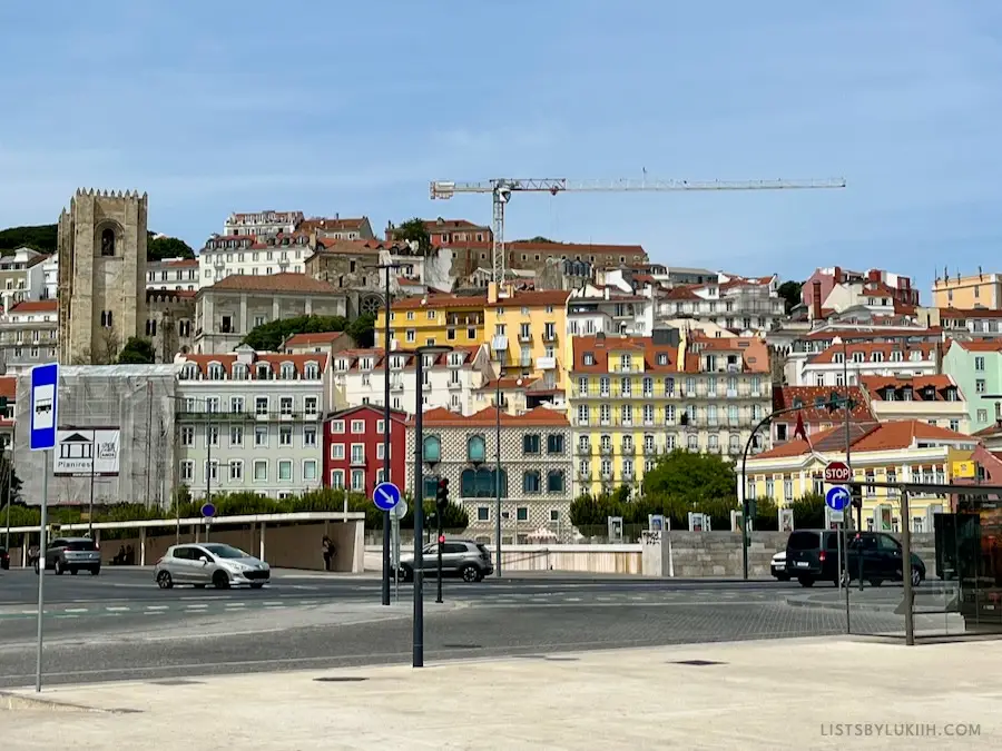 Colorful buildings packed in a city landscape outside a metro station.