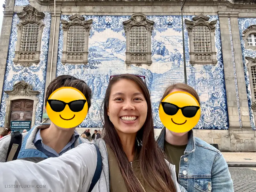 Three women taking a selfie inside a building decorated with blue ceramic tiles.