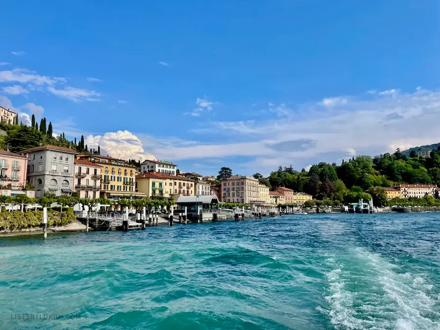 Colorful buildings near the shore of a blue lake.