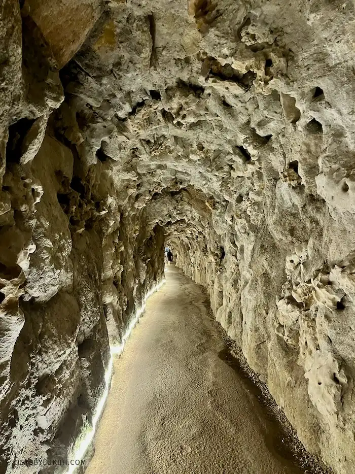 A man-made underground tunnel made out of rocks.