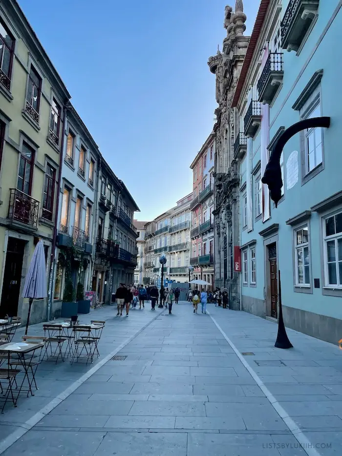 A pedestrian-friendly street surrounded by colorful buildings.