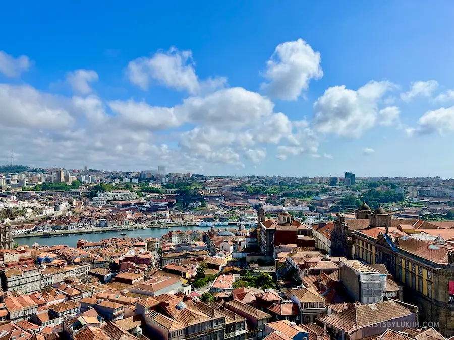 A high up view of a city with many clay, orange rooftops.