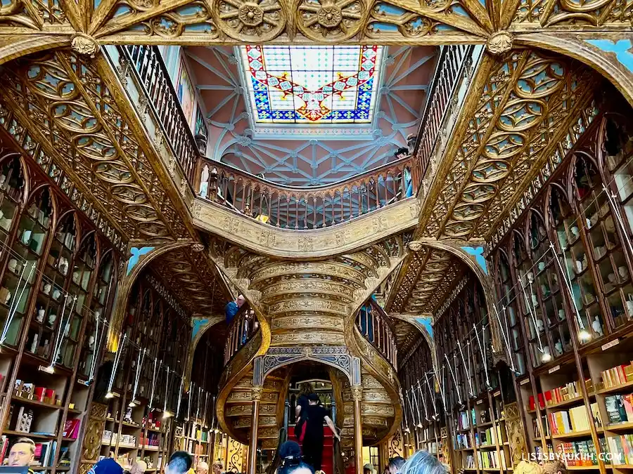 An ornate, golden ceiling of a bookstore.