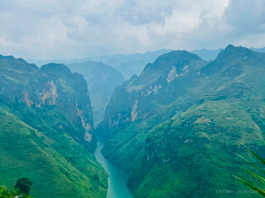 A high view of a deep mountain valley with a river running through it.