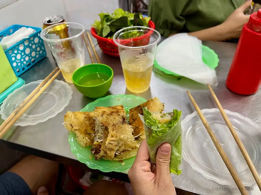 A lettuce wrapped around a crispy pancake with vegetables inside.