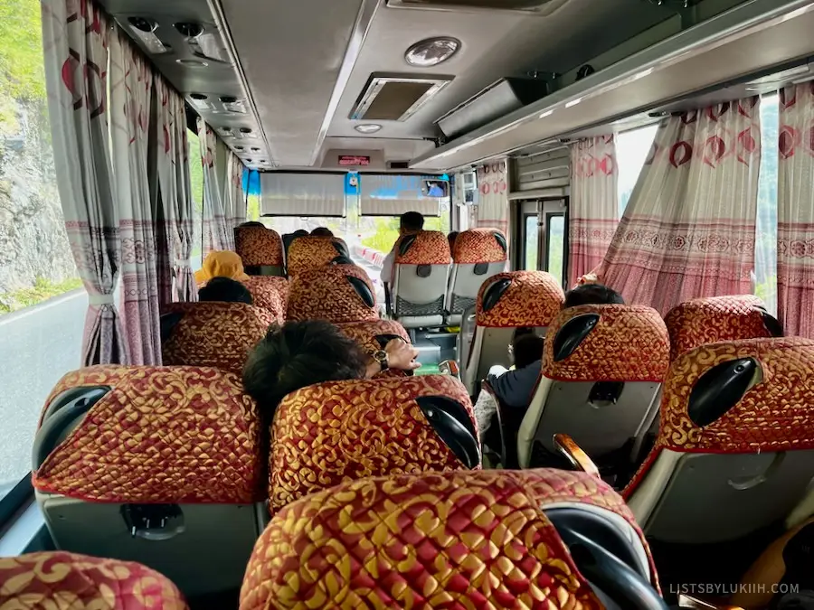 The interior of a bus with decorative seats.