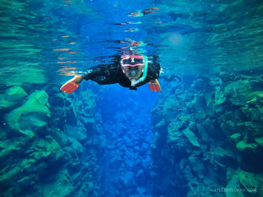 A snorkeler in a wetsuit in very clear water.