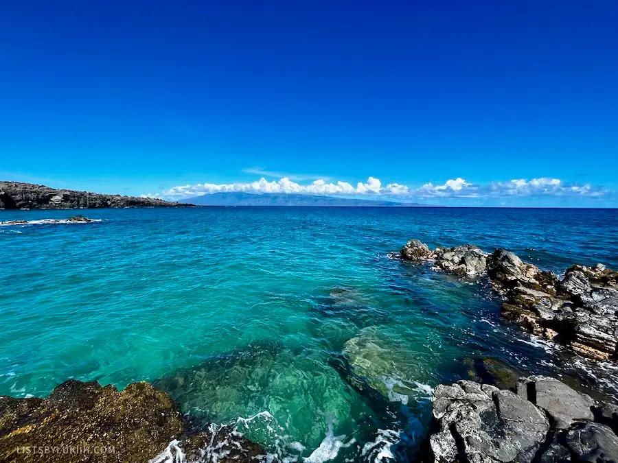 View of a clear, blue ocean with rocks.