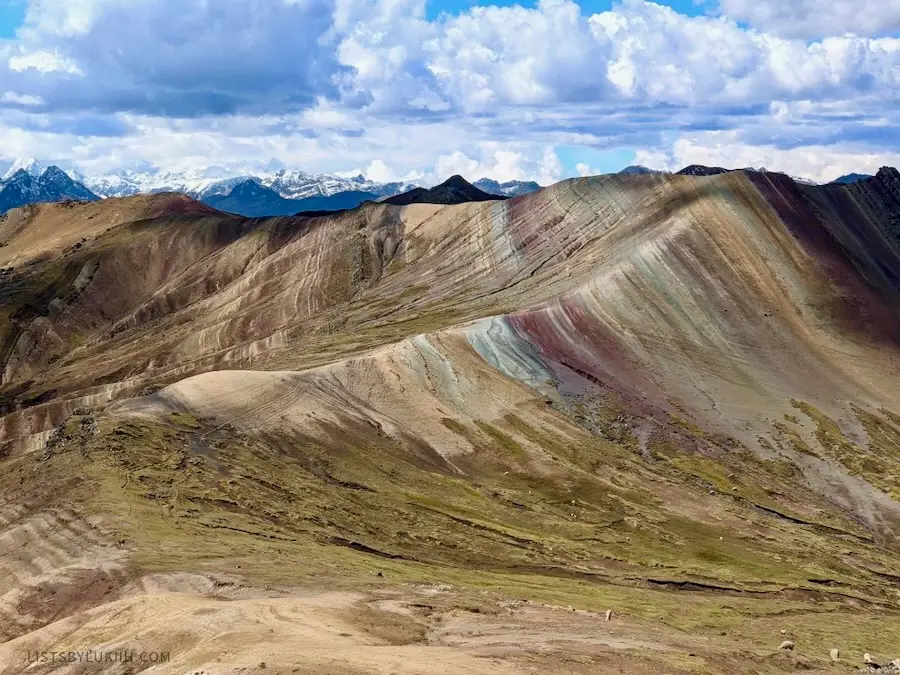 A colorful mountain with maroon, light blue and green colors.