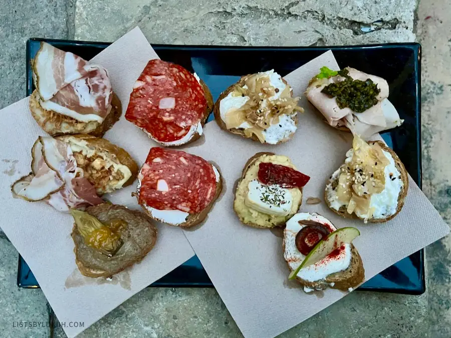 A plate of bread with different savory toppings on it.