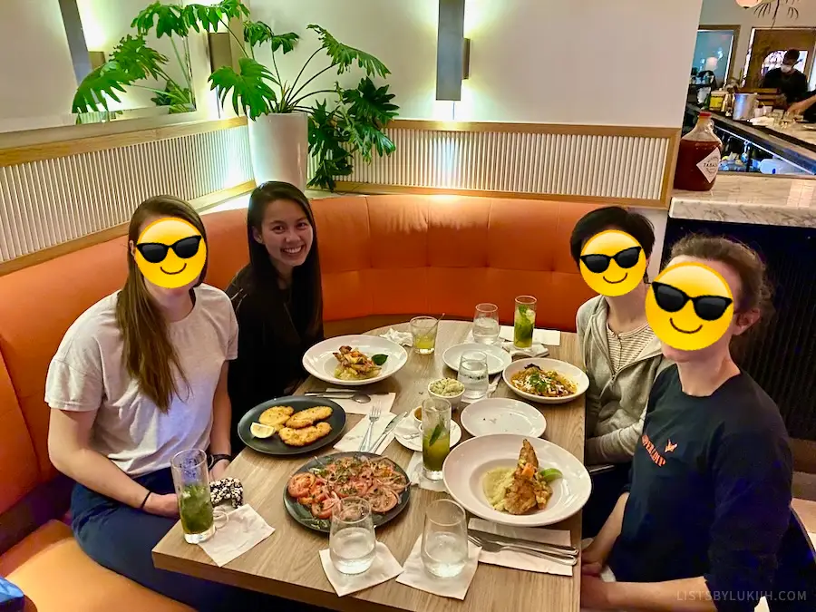 Four people having a seafood dinner at a restaurant.