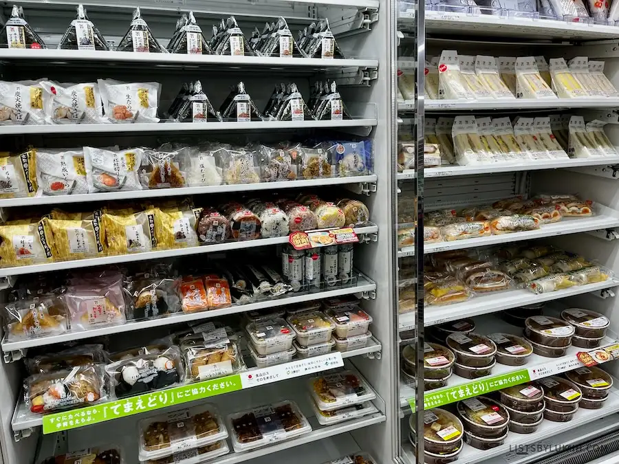A store aisle selling sandwiches and snacks wrapped in seaweed.