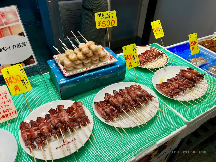 Skewered seafood displayed at a food vendor stall.