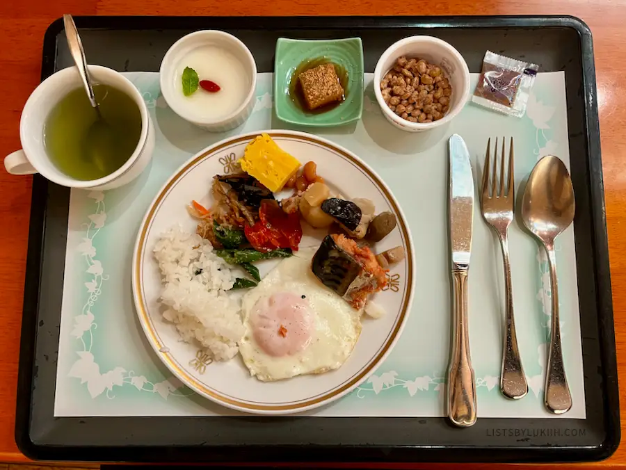 A Japanese style breakfast with egg, rice, beans and pudding.