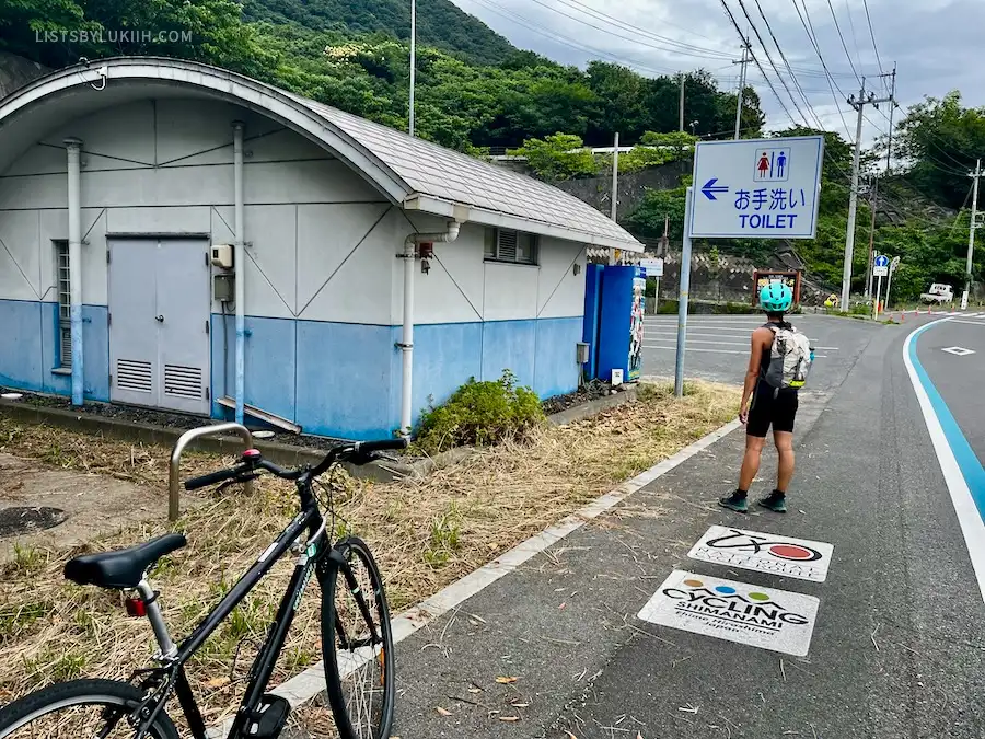 A toilet sign along a bicycle route.