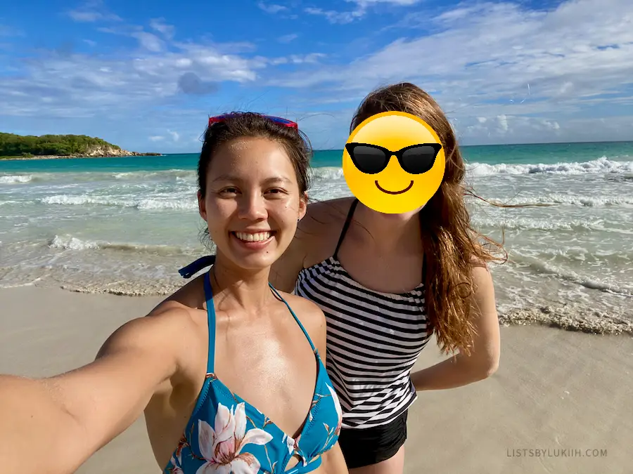 Two women taking a selfie at a beach during a sunny day.