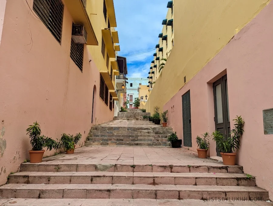 A narrow streets with stairs and colorful buildings.