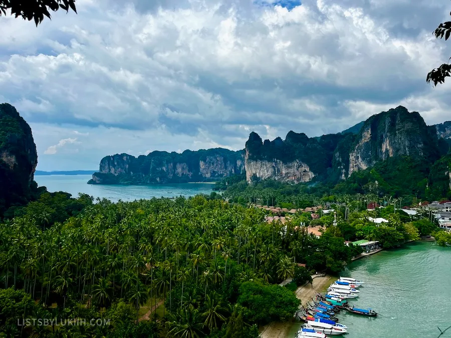 A high view of an island with green trees and limestone cliffs.
