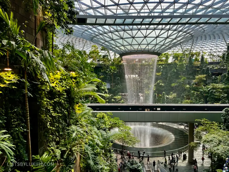 A man-made waterfall shooting out of a modern designed ceiling.