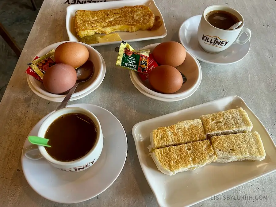 A few plates carrying hard-boiled eggs, toast and coffee.