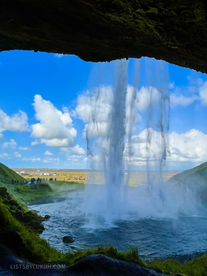 A big waterfall taken from inside a cave.
