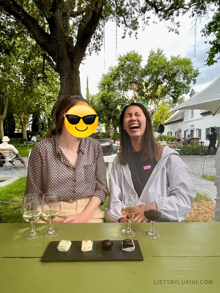 Two women laughing with wine and nougats pairing in front of them.