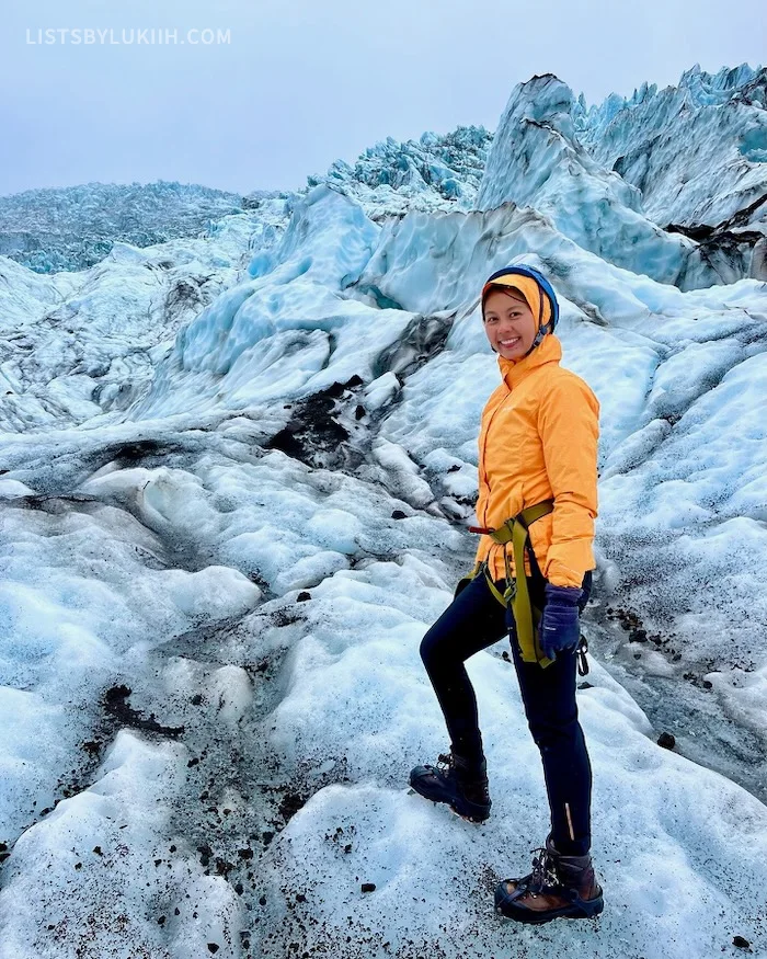 A woman hiking on a glacier, surrounded by ice in all directions.