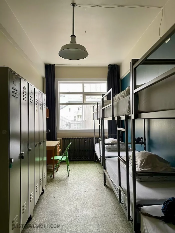 A simple room with multiple bunk beds and lockers.