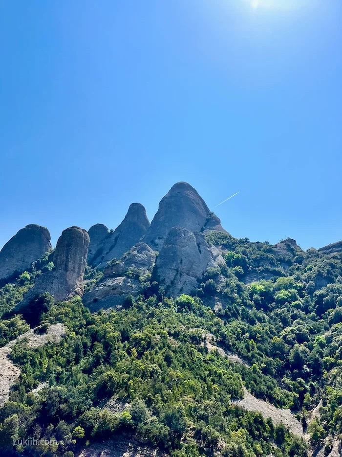 A view of a mountain with multiple rocks jutting out.