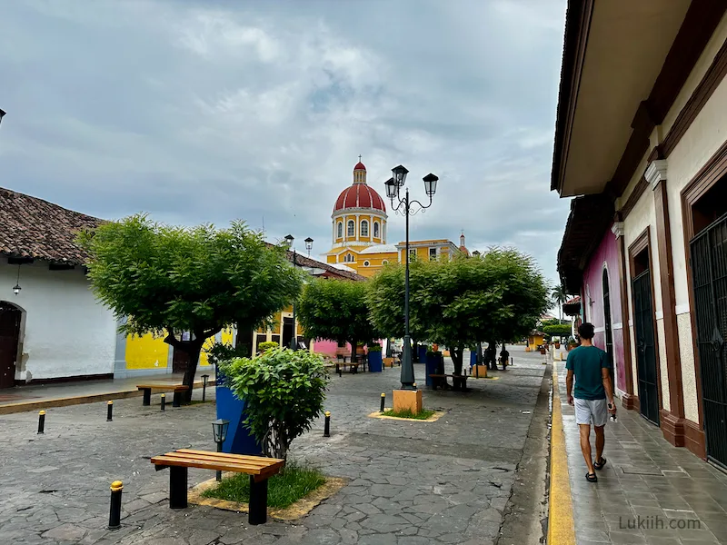 A cobblestone street with a church in the background.