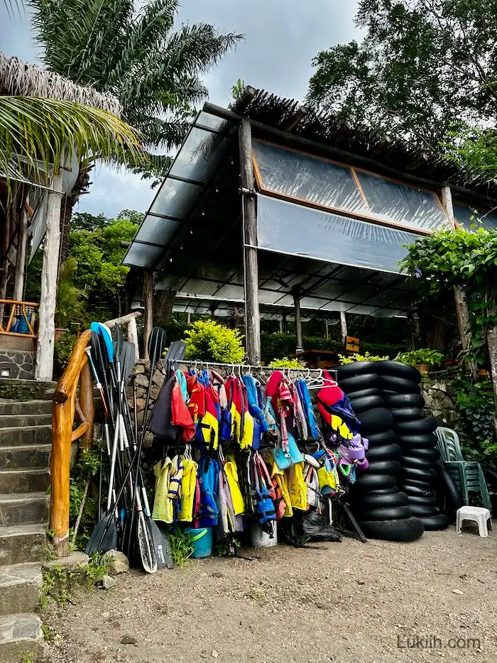 An area with life jackets, paddles, and floatation devices.