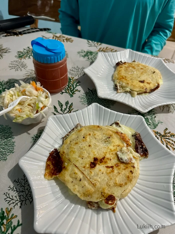 A plate with a flat, cheesy cornmeal cake.