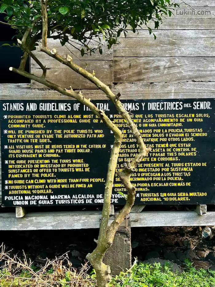 A board attached to a cottage outlining some guidelines for hiking a volcano.