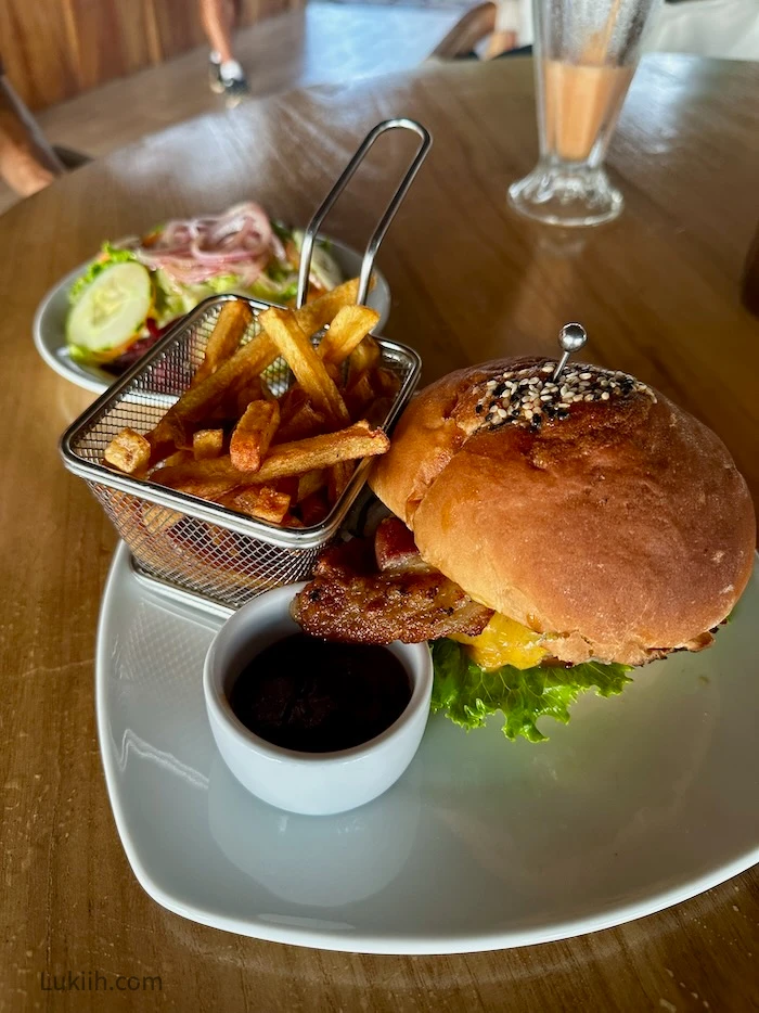 Crispy fries and burger on a table.